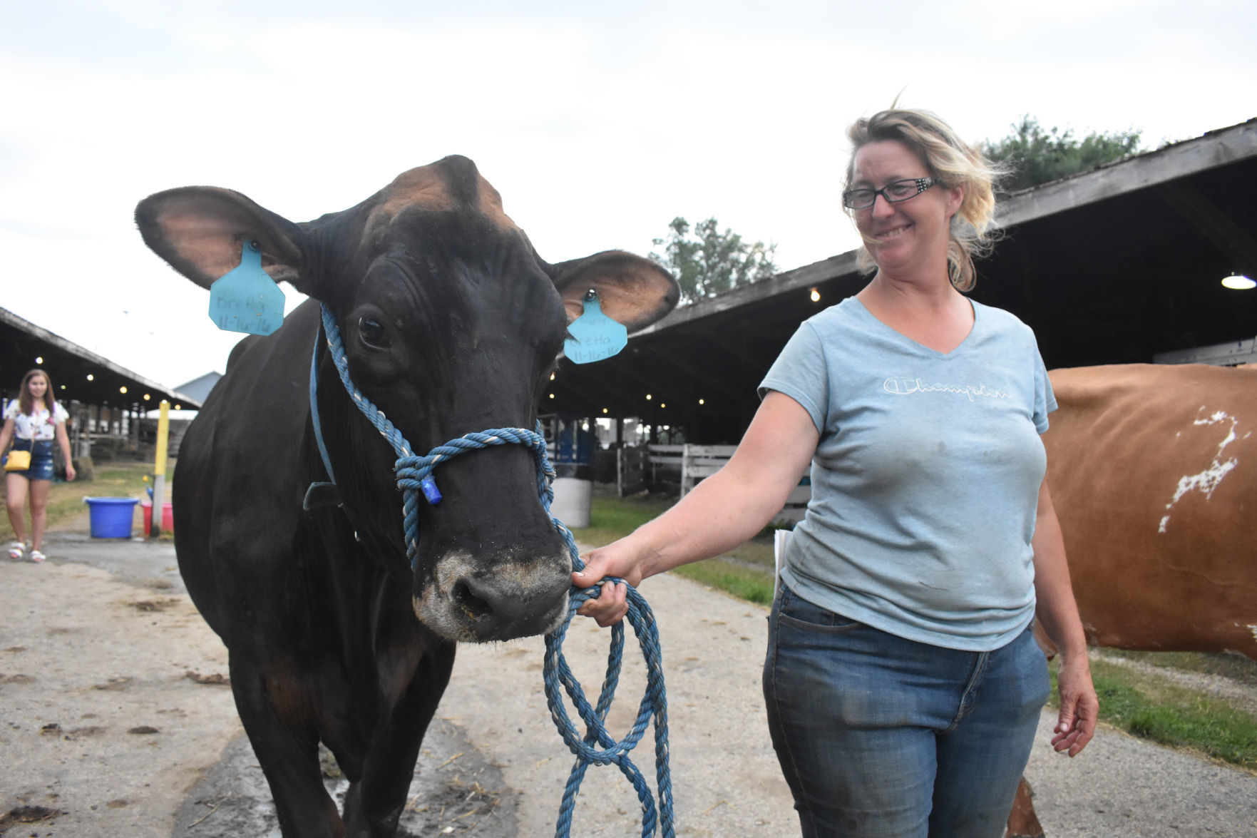 Jenny Jerome walks beside cow